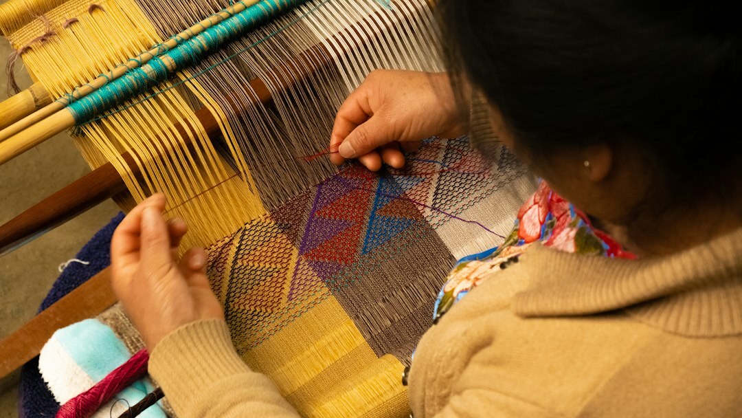 Woman weaving traditional textiles in a rural Chilean home